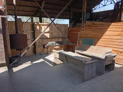a wooden building with a bench and a table at Single-storey holiday home in Heers in Heers