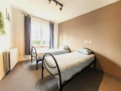 a bedroom with two beds and a window at Single-storey holiday home in Heers in Heers