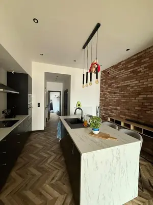 a kitchen with a sink and a brick wall at Premium apartment at the gates of Liège in Liège