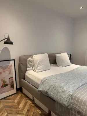 a bed with two pillows on it in a room at Premium apartment at the gates of Liège in Liège