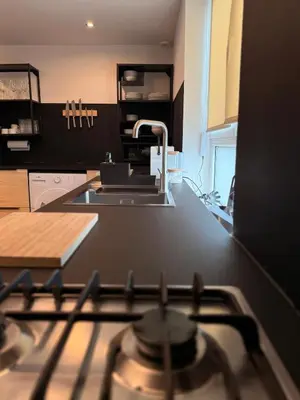 a kitchen with a sink and a stove top oven at Elegance and sweetness of life in Liège in Liège