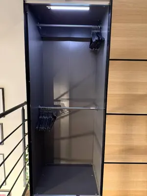 a black refrigerator with its door open next to a cabinet at Elegance and sweetness of life in Liège in Liège