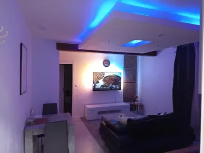 a living room with blue lights on the ceiling at Badoumkassa & Mbanga in Welkenraedt