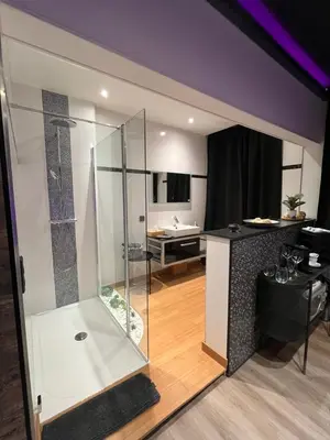 a bathroom with a glass shower in a room at Pause Thermale Suite in Herstal