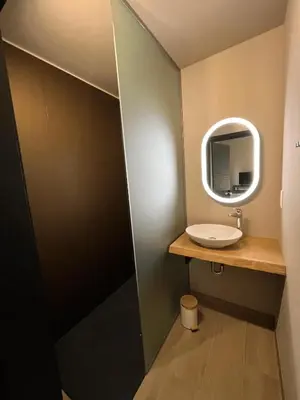 a bathroom with a sink and a mirror at Camping Natuurlijk Limburg - appartement 2p in Voeren