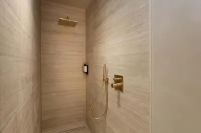 a shower in a bathroom with wooden walls at Woodz Lodges - Unwind in nature in Heusden - Zolder