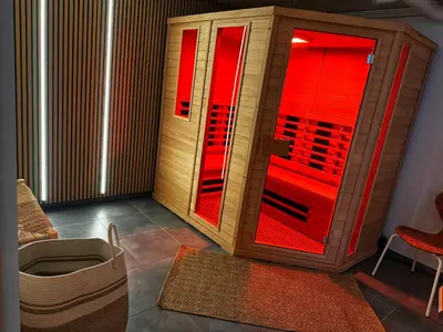a room with a heater and a red window at Le Chen Zen in Dalhem