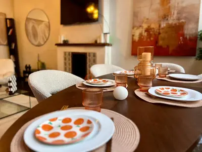 a wooden table with plates of food on it at Clémentine - 3 chambres en Hypercentre in Liège