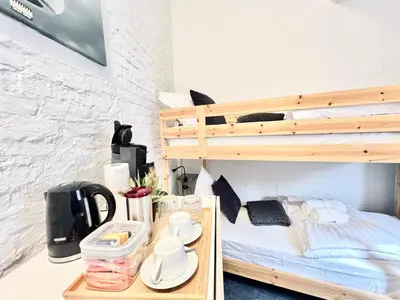 a bedroom with a bunk bed and a desk with a coffee maker at Casa Terraza in Hasselt