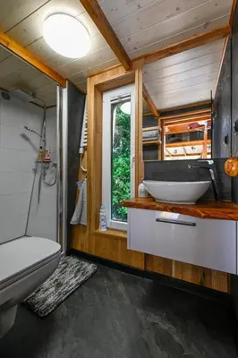 a bathroom with a sink and a toilet and a window at Tiny House Dreiländereck in La Calamine