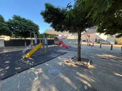 a playground with a yellow slide next to a tree at Modern, child-friendly country house