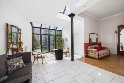 a living room with a couch and a table at Maison de Maître in Liège