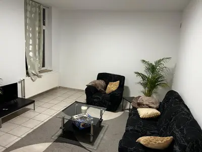 a living room with two couches and a coffee table at Grâce à Liège in Grâce-Hollogne