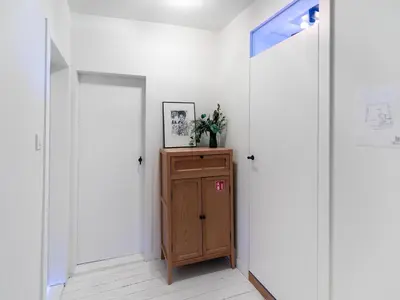 a hallway with two doors and a wooden cabinet at Holiday home in the heart of Hasselt in Hasselt