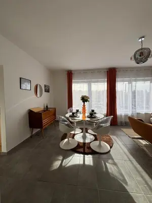 a living room with a table and chairs at Vintage Station in Ans