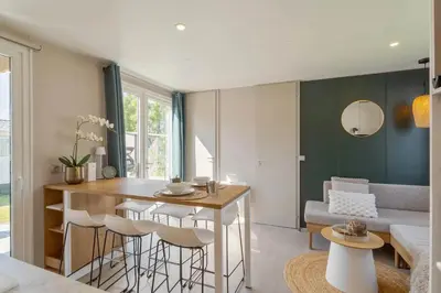 a kitchen and living room with a table and chairs at Camping Papillon Kinrooi - La Casetta in Kinrooi