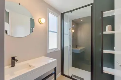 a bathroom with a sink and a mirror at Camping Papillon Kinrooi - Vakantiehuis Premium 4P in Kinrooi