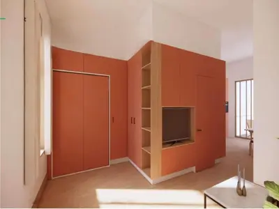 a living room with orange cabinets and a television at Charming ground-floor apartment in Bree in Bree