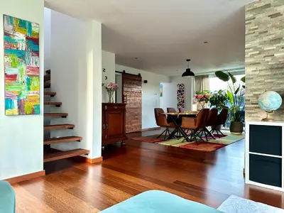 a dining room and living room with a table and chairs at Dukes View -explore Haspengouw & surrounding towns in Zoutleeuw