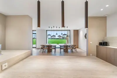 a kitchen and dining room with a table and chairs at De Kompanie in Alken