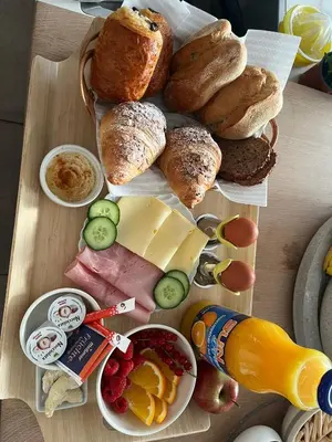 a table topped with different types of bread and pastries at Homestorys Nature Resort - Wood Lounge in Eupen