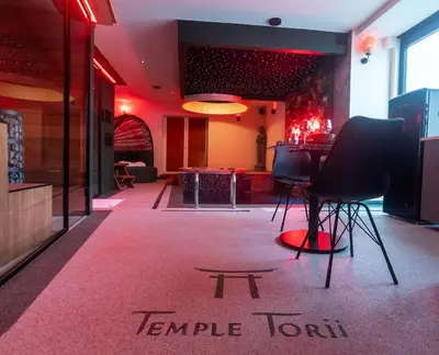 a room with two chairs and a table in it at Temple Torii in Crisnée