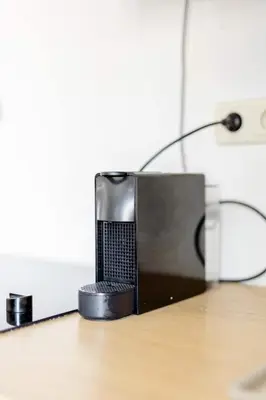 a speaker sitting on top of a desk at L'appartement Casquette in Liège