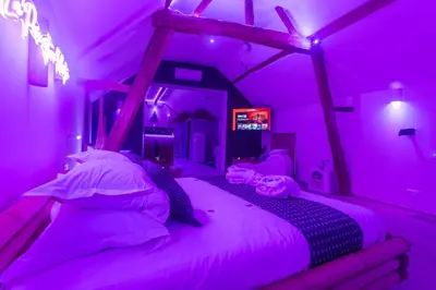 a bedroom with a bed in a purple room at L'Améthyste in Crisnée