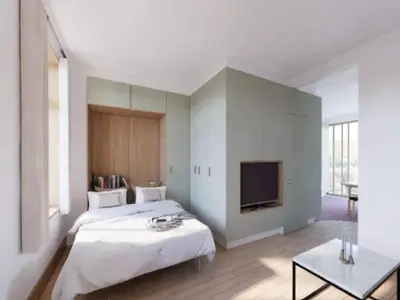 a bedroom with a bed and a flat screen tv at Cosy apartment in Bree for 2 guests in Bree