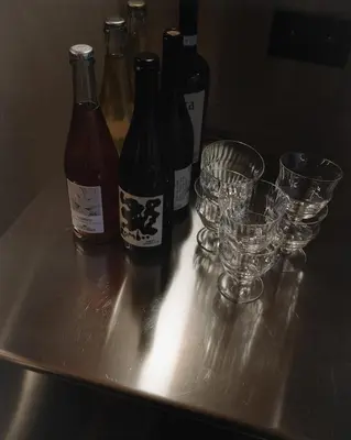 a group of wine bottles and glasses on a table at number nine house in Hasselt