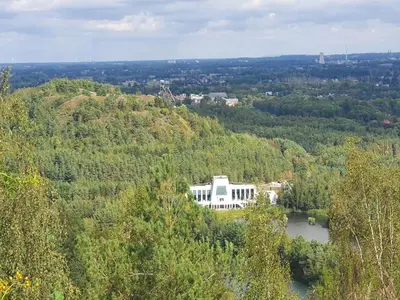 a large white house on a hill with a lake at Lanklaar Chalet with Garden in Lanklaar