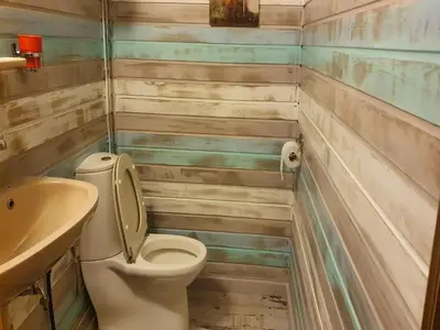 a bathroom with a toilet and a sink at Lanklaar Chalet with Garden in Lanklaar
