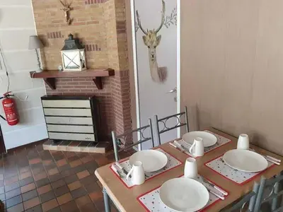 a dining room table with four white plates on it at Lanklaar Chalet with Garden in Lanklaar
