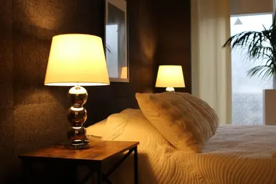 a bedroom with a bed with two lamps on a table at Casa Verde in Maasmechelen