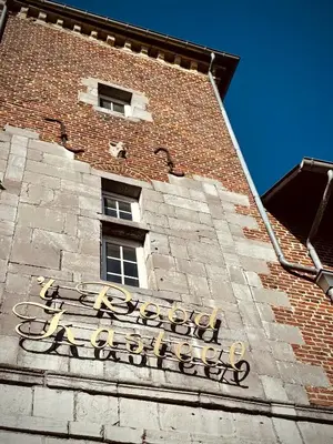 a sign on the side of a brick building at 'T Rood Kasteel in Hasselt