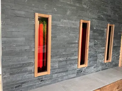 a wall with three windows on a brick wall at Duplex 7 avec Spa Privé in Herstal