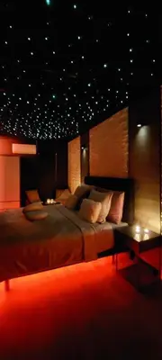 a large bedroom with a large bed and a table at Duplex 7 avec Spa Privé in Herstal