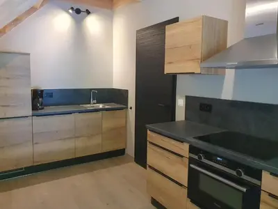 a kitchen with a sink and a counter top at Camping Natuurlijk Limburg - Appartement 6p in Voeren