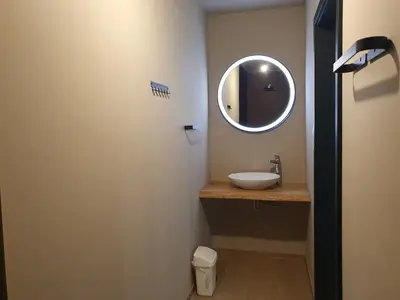 a bathroom with a sink and a mirror at Camping Natuurlijk Limburg - Appartement 6p in Voeren