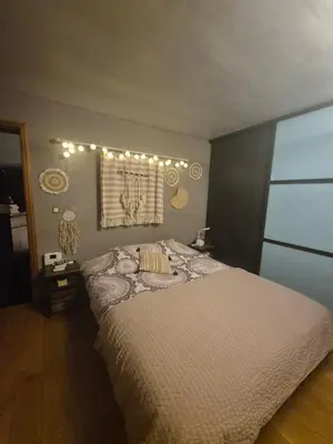 a bedroom with a bed and a window with lights at Villa Marvin in Soumagne