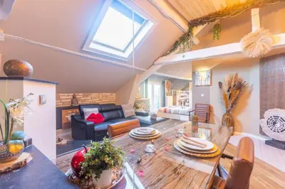 a living room with a table and a couch at Apartment Design Suite in Jehanster