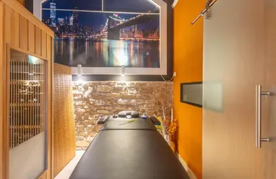 a bathroom with a tv on a wall with a sink at Apartment Design Suite in Jehanster