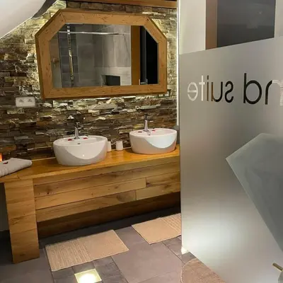 a bathroom with two sinks and a mirror at Apartment Design Suite in Jehanster