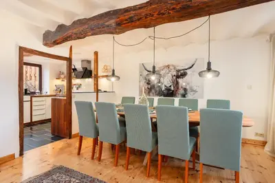 a dining room with a table and chairs at Zum Alten Kuhstall - Südgarten & Terrasse - Großes Landhaus mit Sauna in Lontzen
