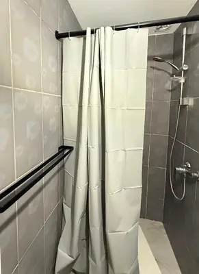 a bathroom with a shower with white towels at Duplexe Cosy - HERSTAL in Herstal
