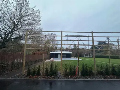 a garden with a fence in front of a building at Grand Fields in Heusy