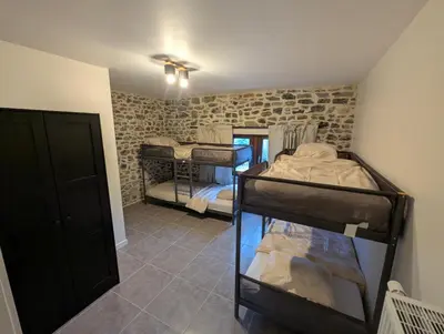 a bedroom with two bunk beds in a room at Le Marie-Rose Charme et Pierre Porte des Fagnes in Baelen