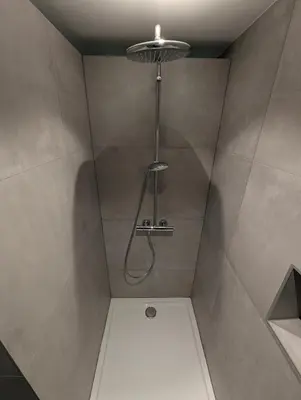 a shower with a shower head in a bathroom at Le Marie-Rose Charme et Pierre Porte des Fagnes in Baelen