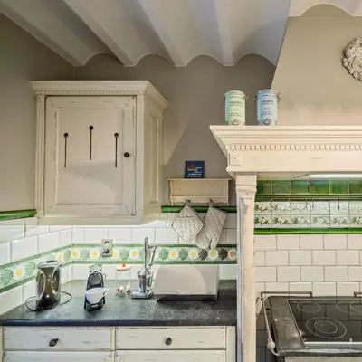 a kitchen with a sink and a counter top at Vakantiewoning Begijnhof 54 in Sint-Truiden