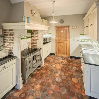 a large kitchen with a stove and a sink at Vakantiewoning Begijnhof 54 in Sint-Truiden